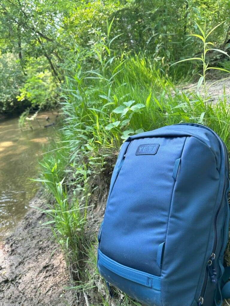 https://www.cookoutnews.com/wp-content/uploads/2023/08/Yeti-Crossroads-Backpack-by-a-River-768x1024.jpg