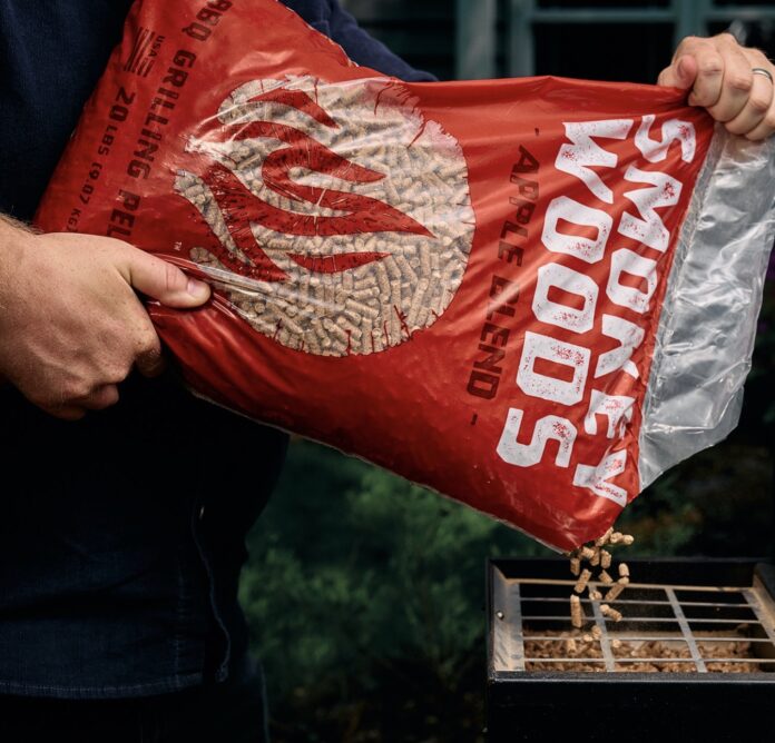 Smokey Woods BBQ Pellets Loading into a Pellet Grill