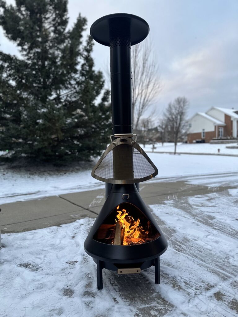 Burning Logs in the TIKI Brand Chiminea Outdoor Fireplace - Tall